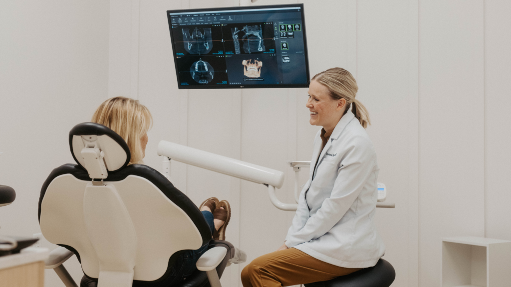 Dentist discussing tooth pain relief with a patient at Birk Family Dentistry